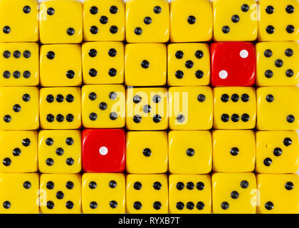 redBackground of random ordered yellow dices with two red cubes Stock Photo