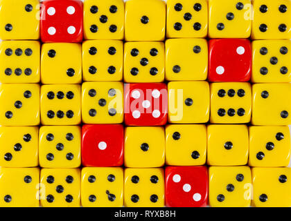 Background of random ordered yellow dices with five red cubes Stock Photo