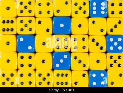 Background of random ordered yellow dices with six blue cubes Stock Photo