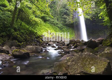 Beautiful Cascading Waterfall Landscape, Lush Green Foliage in Costa Rica Tropical Rainforest Jungle near La Fortuna in Arenal Volcano National Park Stock Photo