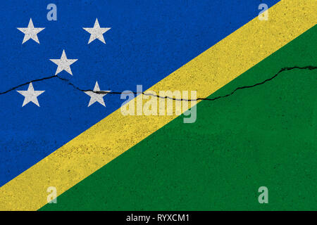 Solomon Islands flag on concrete wall with crack. Patriotic grunge background. National flag of Solomon Islands Stock Photo