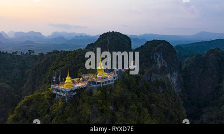 View from above, stunning aerial view of the beautiful Tiger Cave Temple (Wat Tham Sua) surrounded by amazing ridges of limestone mountains. Stock Photo