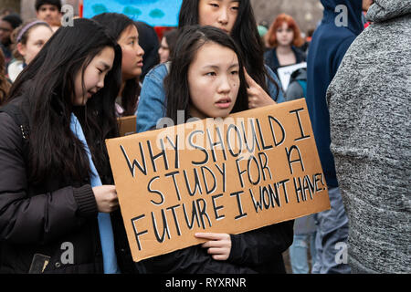 Chicago, USA. 15th Mar, 2019. As part of the world wide 'Youth Climate Strike' a spirited group of Chicago area young folks left their schools this morning, gathered near the Field Museum and marched through Grant Park to Federal Plaza in the loop, chanting their commitment to ending the threat of climate change. In the plaza, young speakers, mostly students from area high schools, exhorted the crowd to hold the government accountable by 'registering to vote, showing up at the polls, and voting them out'  if elected officials deny that climate change is a threat. Credit: Matthew Kaplan/Alamy L