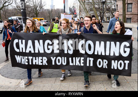 Demonstrators seen marching with a banner saying, change is coming, during the Youth Climate Strike protest walking from Columbus Circle to the American Museum of Natural History in New York City, NY. Stock Photo
