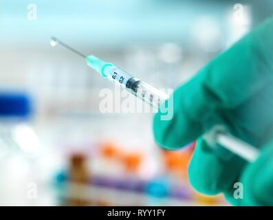 Doctor preparing a dose of medicine to give to a patient. Stock Photo