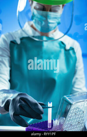 Technician preparing biological sample for deep freezing. Stock Photo