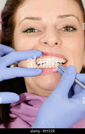 Orthodontist tightening braces. Stock Photo