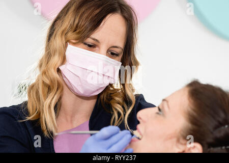 Orthodontist tightening braces. Stock Photo
