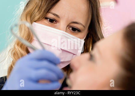 Orthodontist tightening braces. Stock Photo
