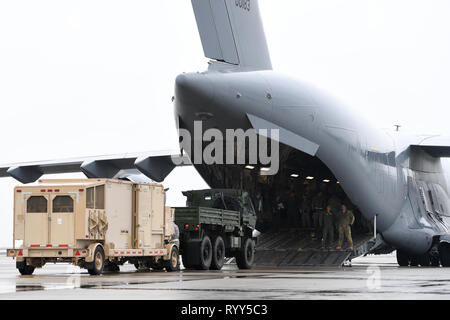 Members from the 235th Air Traffic Control Squadron, 145th Logistic Readiness Squadron, Small Air Terminal, and 156th Airlift Squadron worked together to prepare equipment for transportation at the North Carolina Air National Guard Base, Charlotte Douglas International Airport, Mar. 10, 2019. Members conduct training to load air traffic control equipment aboard a C-17 Globemaster III aircraft. This training helps to prepare air traffic control members with the transportation and setup of a deployable airfield. Stock Photo