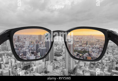 Looking through glasses to city view in sunset. Color blindness glasses, Smart glass technology Stock Photo