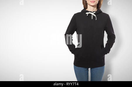 young girl in black sweatshirt, black hoodies front view isolated on white background. mock up Stock Photo