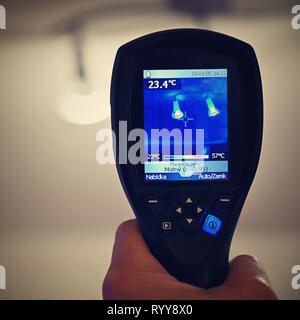 Hand thermal imaging camera to check temperature . Stock Photo