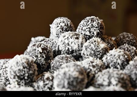 Rum balls. Traditional Czech Christmas cookies. Cocoa coated in coconut. Stock Photo