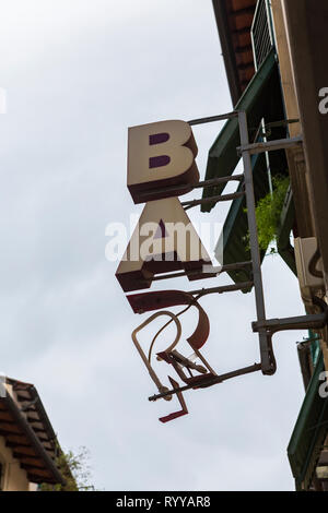 Busted neon sign at the entrance of a bar in Florence, Tuscany, Italy. Stock Photo