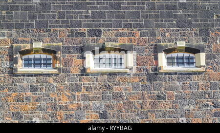 One of the many small grills windows on the jail building in Belfast Stock Photo