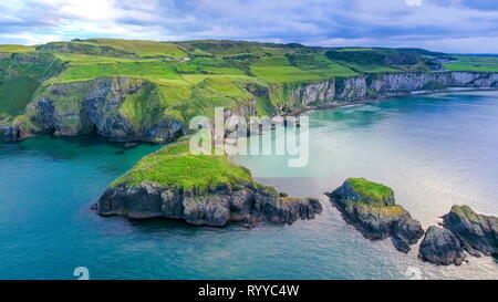The aerial view of the two islands in Carrick-a-Rede with the rope bridge connecting the two islands in Ireland Stock Photo