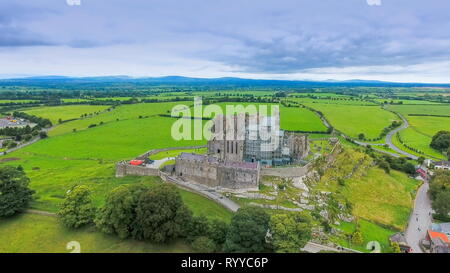 The aerial view of the Rock of Cashel and the green fields on the back of the old ruined castle in Ireland Stock Photo