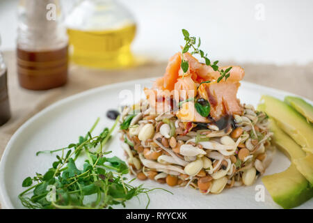 Salad of germinated seeds, trout and avocado. Macrobiotic food concept. Stock Photo