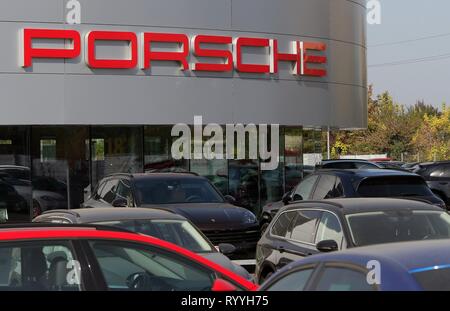 Bucharest, Romania - October 17, 2018: The logo of Porsche car brand is seen on a showroom in Bucharest, Romania. This image is for editorial use only Stock Photo