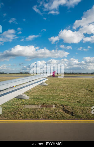 Luton, England - September 2018 : Window view of a wing of an aircraft during landing on the airport Stock Photo