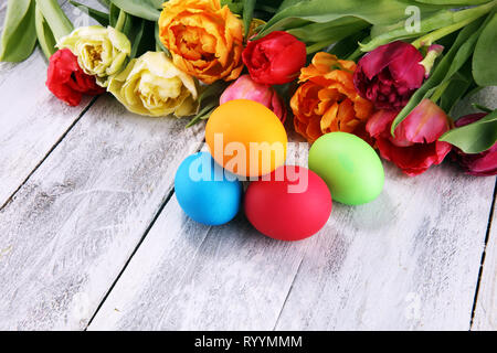 Festive table setting for Easter with colorful eggs and tulip on spring Stock Photo