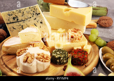 Cheese plate served with figs, various cheese on a platter on wooden table Stock Photo
