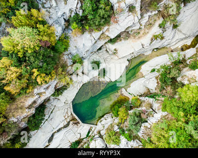 Aerial top down view of Papingo Rock Pools, also called ovires, natural green water pools located in small smooth-walled gorge near the village of Pap Stock Photo