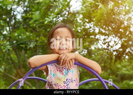 Asian girl smiling in a playground. Filipina kid Stock Photo