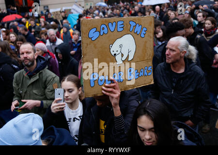 Brussels, Belgium. 15th Mar, 2019. A person holding a placard takes part in a demonstration against climate change in Brussels, Belgium, March 15, 2019. Thousands of school students across Belgium abandoned classrooms for a day of climate demonstrations on Friday as part of the 'Global Strike for Future', local press reported. Credit: Zhang Cheng/Xinhua/Alamy Live News Stock Photo