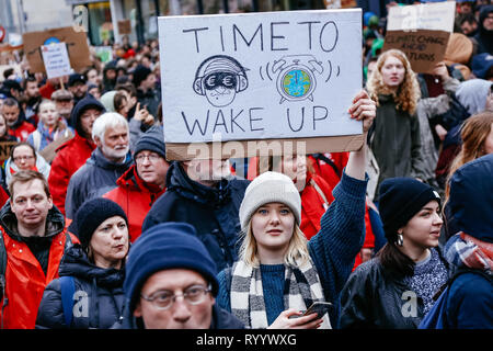 Brussels, Belgium. 15th Mar, 2019. A woman holding a placard takes part in a demonstration against climate change in Brussels, Belgium, March 15, 2019. Thousands of school students across Belgium abandoned classrooms for a day of climate demonstrations on Friday as part of the 'Global Strike for Future', local press reported. Credit: Zhang Cheng/Xinhua/Alamy Live News Stock Photo