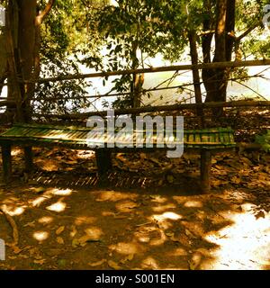 Long wooden bench in a park Stock Photo