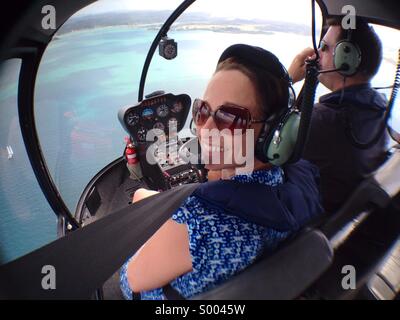 Tourists take a helicopter trip over the bay of islands in New Zealand's north island. January 2014 Stock Photo