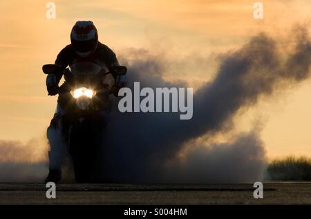 Motorcycle burnout, sunset Stock Photo