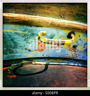 A painted door handle on an old colorful rusted car Stock Photo