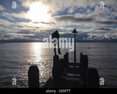 Sillhouette of a man on a pier Stock Photo