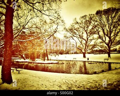 Duck pond in a park with snow in winter Stock Photo