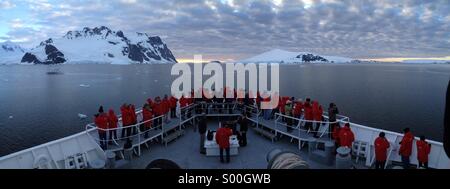 Passengers on bow of Antarctic cruise ship, Lemaire Channel, Antarctica Stock Photo