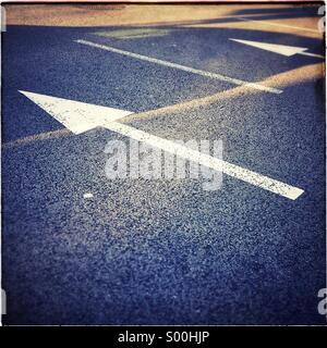 One direction traffic sign. Arrows on asphalt road. Stock Photo