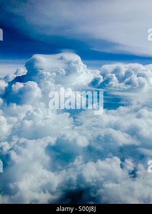 Flying high above heavy weather and storms in an airliner. Stock Photo