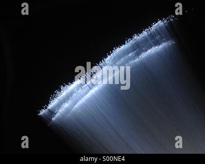 Flattened bundle of optical fibers on black background Stock Photo