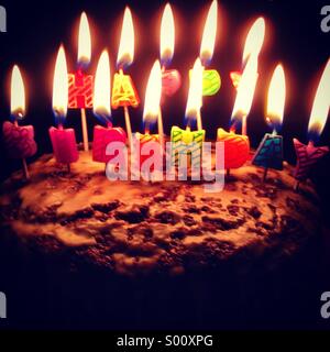 Happy birthday candles on a cake Stock Photo