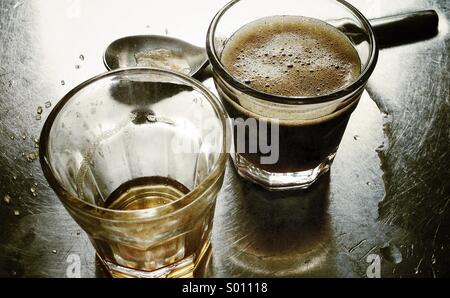 Two espresso intense coffee shots on a stainless steel serface Stock Photo