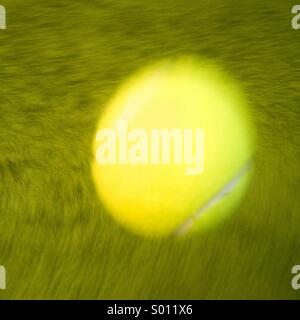 Moving tennis ball on Grass Court Stock Photo
