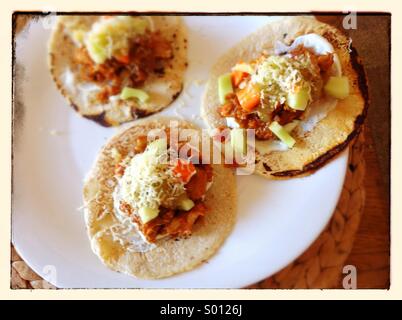 Three mexican tacos on a white plate Stock Photo