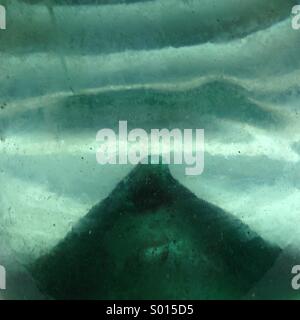 Abstract view of Pontil inside of antique hand blown bottle. Stock Photo