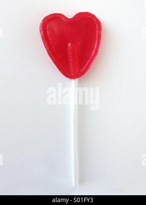 Red heart-shaped lollipop. Stock Photo