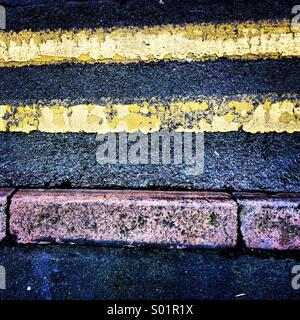 Double Yellow Lines and Pavement Kerb. Stock Photo