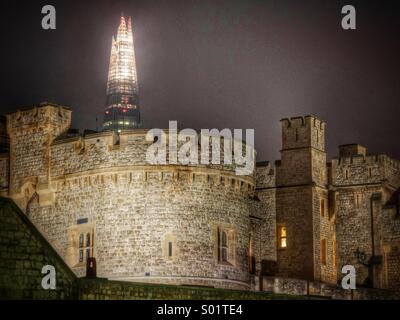 Tower of London at night with the Shard skyscraper behind it - juxtaposition of ancient and modern Stock Photo