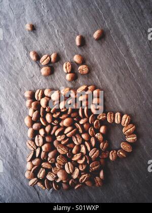 Coffee beans shaped to resemble a cup of coffee. Stock Photo